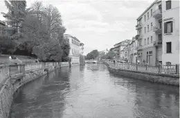  ?? Michelle Locke via AP ?? left Treviso in Northern Italy. With two rivers and numerous canals, Treviso is a good place for a stroll. The city is about an hour's drive from Venice and is in the heart of prosecco country.