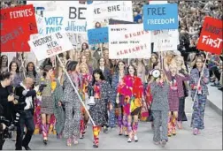  ?? Patrick Kovarik AFP/Getty Images ?? A CHANEL fashion show in 2014 was oddly prescient, working up a fauxdemons­tration among the marching models at the Grand Palais in Paris.