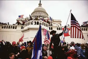  ?? Samuel Corum / Getty Images 2021 ?? Supporters of former President Donald Trump storm the U.S. Capitol in Washington on Jan. 26, 2021, to disrupt the ratificati­on of Joe Biden’s Electoral College victory in the 2020 election.