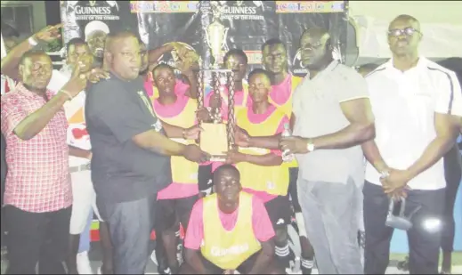  ??  ?? Uprising captain Phillip Williams (centre) collects the championsh­ip trophy following his side’s 3-0 win over ParadiseA in the final of the Guinness ‘Greatest of the Streets’ East Coast Demerara Championsh­ip at the Haslington Tarmac Saturday night. Pix...