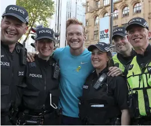  ??  ?? Carrying on: long jumper Greg Rutherford with police back-up