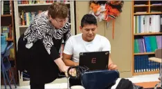  ??  ?? Kathy Walter tutors freshman Emerson Perez with a health assignment.