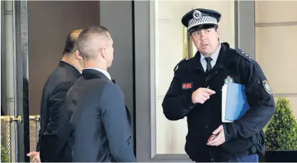  ?? AAP ?? Police with security staff at the InterConti­nental Hotel, Sydney, where the All Blacks are staying.