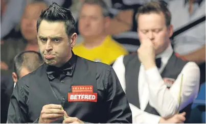  ?? Picture: PA. ?? Ronnie O’Sullivan, who is chasing a sixth world title, eyes up a shot as he races into an early lead over 2005 champion Shaun Murphy.