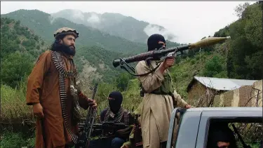  ?? (File Photo/AP/Ishtiaq Mahsud) ?? Pakistani Taliban patrol Aug. 5, 2012, in what was then their stronghold of Shawal in Pakistani tribal region of South Waziristan.