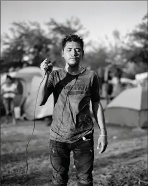  ?? (Special to the Democrat-Gazette/Adam Ferguson) ?? Linifir Lopez, 33, is shown at an informal migrant camp in Reynosa, Mexico, in a photo taken by Adam Ferguson and Lopez. This image is part of “Migrantes,” an exhibit at Windgate Museum of Art at Hendrix College in Conway.