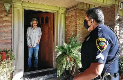  ?? Bob Owen / Staff photograph­er ?? Cpl. Victor Mata of the Balcones Heights Police Department visits Michael Guerrero, 67, as the department plans to check on every resident in the city. “We were kind of homebodies even before all this, so it’s not much of a change for us,” Guerrero said with a laugh.