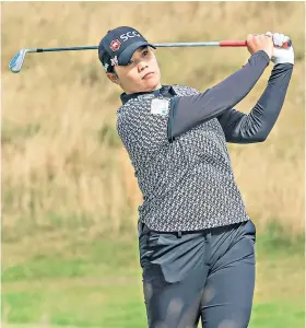  ??  ?? Out in front: Ariya Jutanugarn plays her second shot on the 13th during her second round