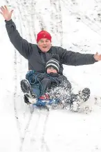  ?? Pictures: Tina Norris/PA. ?? Mark Doughty and son Tom from Limekilns sledging in the Glen, Dunfermlin­e.