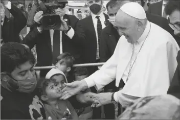  ?? ALESSANDRA TARANTINO/AP ?? POPE FRANCIS MEETS MIGRANTS during his visit at the Karatepe refugee camp, on the northeaste­rn Aegean island of Lesbos, Greece Sunday.