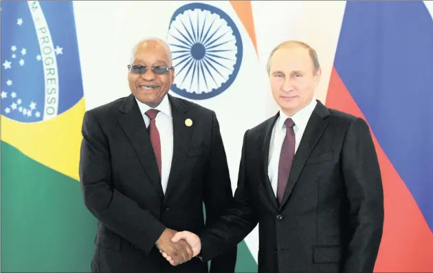  ?? PICTURE: MIKHAIL KLIMENTYEV /REUTERS ?? EXTERNAL SAVIOUR?: It has been alleged that Russian President Vladimir Putin sent his officials to meet Jacob Zuma shortly before South Africa’s president reshuffled his cabinet. The two men are seen shaking hands at the Brics leaders meeting ahead of...
