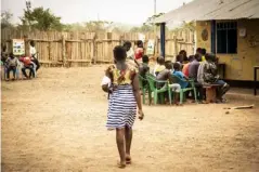  ??  ?? Martha queues up with other children to receive a document in Yambio saying she has been released from the army