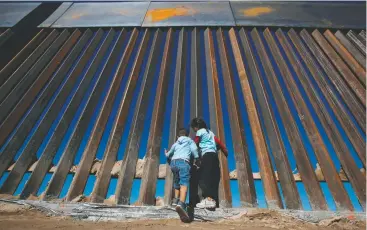  ?? JOSE LUIS GONZALEZ/REUTERS ?? In an image shot from inside Mexico, children play Nov. 18, 2016, at a newly built section of the U.S.-Mexico border fence at Sunland Park, N.M., opposite the Mexican city of Juarez.