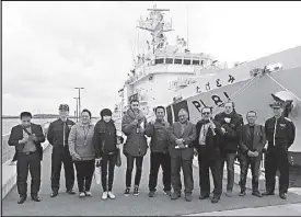  ?? JAIME LAUDE ?? Foreign journalist­s pose in front of a Japanese coast guard vessel docked at the Ishigaki port in Okinawa, Japan. The JCG committed 16 of this 1,500-ton ship to secure its southern front and other areas in the East China Sea.