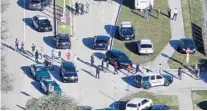 ?? MIKE STOCKER/SUN SENTINEL ?? Students are evacuated by police out of Marjory Stoneman Douglas High School in Parkland after a shooter opened fire on the campus.