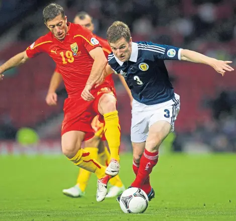  ?? Pictures: SNS Group. ?? Left: Paul Dixon leads the celebratio­ns after United scored against St Johnstone on their way to the 2010 Scottish Cup final; above: the full-back in action for Scotland against Macedonia in 2012.