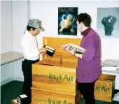  ??  ?? Charlie Kogvik and an unidentifi­ed woman pack Library Boxes with videotapes and books before they go north, 1992