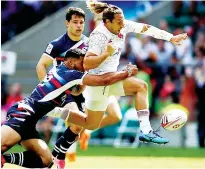  ??  ?? Evasion: England’s Dan Bibby kicks the ball away from the USA’s Martin Iosefo