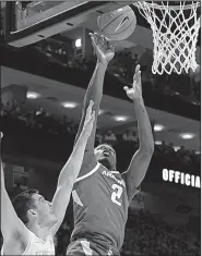  ?? AP/SHAWN MILLSAPS ?? Arkansas forward Adrio Bailey (2) shoots over Tennessee forward John Fulkerson during the Razorbacks’ 106-87 loss to the No. 3 Volunteers on Tuesday at Thompson-Boling Arena in Knoxville, Tenn.