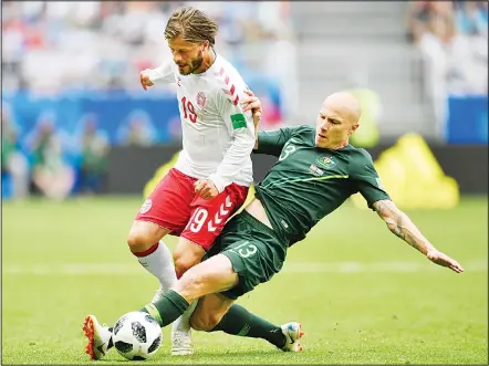  ??  ?? Denmark’s Lasse Schone is challenged by Australia’s Aaron Mooy (right), during the Group C match between Denmark and Australia at the 2018 soccerWorl­d Cup in the Samara Arena in Samara, Russia on June 21.