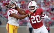  ?? TONY AVELAR ?? Stanford running back Bryce Love (20) stiff-arms Southern California cornerback Iman Marshall (8) during the first half of an NCAA college football game, Saturday, Sept. 8, in Stanford, Calif.