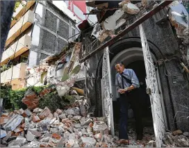  ?? MARCO UGARTE / ASSOCIATED PRESS ?? A man exits a building that collapsed after Tuesday’s quake in the Condesa neighborho­od of Mexico City. Earlier in the day workplaces across the city had readiness drills to mark the anniversar­y of the 1985 quake, a magnitude 8.0 temblor that killed...