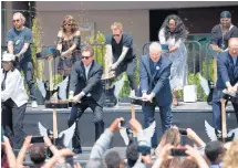  ?? KYLE TELECHAN/ POST-TRIBUNE ?? Musicians, local politician­s, and casino administra­tors bring down their guitars during the grand opening guitar smash Friday at Hard Rock Casino Northern Indiana.