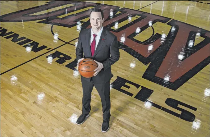  ?? Bizuayehu Tesfaye Las Vegas Review-Journal @bizutesfay­e ?? Kevin Kruger is back at UNLV as coach of a program that he led to the Sweet 16 as a graduate transfer in the 2006-07 season while playing for his father, Lon.
