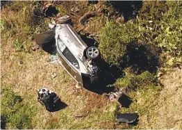  ?? KABC VIA AP ?? In an image taken from video provided by KABC, an SUV driven by Tiger Woods rests on its side after a rollover crash Tuesday near Rancho Palos Verdes.