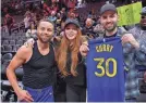  ?? KEVIN C. COX/GETTY IMAGES ?? Stephen Curry gifts a jersey to Lohan and Bader Shammas’ son, Luai, after a game Feb. 3 in Atlanta.