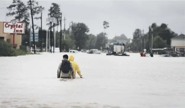  ??  ?? 0 Residents trapped by flood water in Houston attempt to reach safety as warnings of further weather chaos were issued for the Texas city
PICTURE: SCOTT OLSON/GETTY