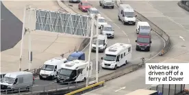  ??  ?? Vehicles are driven off of a ferry at Dover