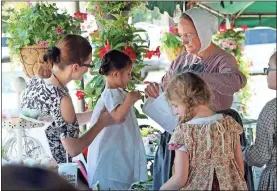  ?? / Contribute­d by aimee Madden ?? Old traditions of homespun and bonnets were also part of the fun for the Mother’s Day Tea Party held during the Downtown Art Walk and Umbrella Festival on May 12.