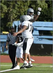  ?? OWEN MCCUE - MEDIANEWS GROUP ?? Pottstown’s Nyles Bunn-McNeil, right, and Josiah Wilson celebrate after Bunn-McNeil’s touchdown catch Friday against Lower Merion.