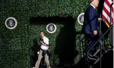  ?? York Times Co. Doug Mills, © The New ?? Shealah Craighead, then the official White House photograph­er, looks on as then- President Donald Trump takes the stage to speak at an event in Williamsbu­rg, Va., on July 30, 2019.