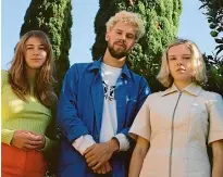  ??  ?? Gussie Larkin, right, formed The Mermaidens with high school friends Lily West, left, and Abe Hollingswo­rth, centre, in 2013.