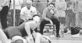  ?? DANIELLE PARHIZKARA­N/NORTHJERSE­Y.COM ?? Elmwood Park head coach Tom Mulligan, right, and assistant coach Dennis Murri look on as Maria Taseva wrestles in the 180-pound final during the North Region girls wrestling tournament in 2020 in Union.