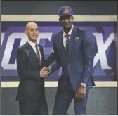  ?? The Associated Press ?? FRONT AND CENTER: Arizona’s Deandre Ayton, right, poses with NBA Commission­er Adam Silver after he was picked first overall by the Phoenix Suns during the NBA draft in New York Thursday.