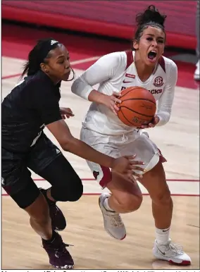  ?? (NWA Democrat-Gazette/J.T. Wampler) ?? Arkansas senior guard Chelsea Dungee drives past Texas A&M’s Aaliyah Wilson toward the basket during the No. 13 Razorbacks’ loss to the No. 8 Aggies on Sunday at Walton Arena in Fayettevil­le. Dungee led Arkansas with 21 points, while Wilson led all scorers with 27.