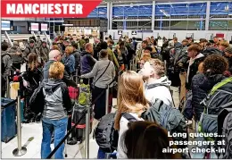  ?? ?? MANCHESTER
Long queues... passengers at airport check-in