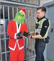  ??  ?? ‘Arresting’ officer PC Jack Baker with the Grinch, played by PC Jason Millar.