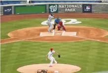  ?? AP PHOTO/ANDREW HARNIK ?? The Washington Nationals’ Max Scherzer throws the first pitch of the 2020 MLB season to the New York Yankees’ Aaron Hicks on Thursday night at Nationals Park.