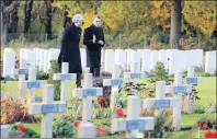  ?? AP PHOTO ?? British Prime Minister Theresa May and French President Emmanuel Macron visit the Thiepval cemetery as part of ceremonies to mark the centenary of the 1918 Armistice, in Thiepval, northern France, Friday.