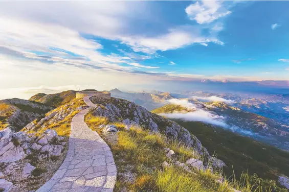  ?? PHOTOS: GETTY IMAGES ?? The sun sets over Lovcen Mountains National park in Montenegro. The small and mountainou­s Balkan nation has sat at crossroads of history for thousands of years.