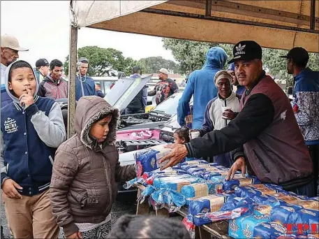  ??  ?? FOR A GOOD CAUSE: Motoring enthusiast­s from Lentegeur in Mitchells Plain have come together to make a positive impact in their community by starting a soup kitchen. Requests to use an open space in the area have been ignored by the City.