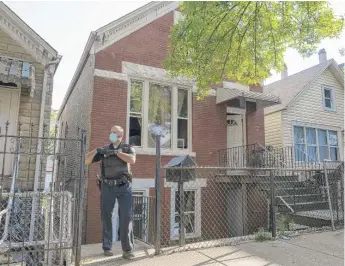  ?? TYLER LARIVIERE/SUN-TIMES ?? Chicago police and Peoples Gas employees at the home where two women were found dead from carbon monoxide poisoning in the 2800 block of West 22nd Place in Little Village on Friday.