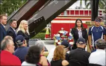  ??  ?? Village of Wellington council members and volunteers who helped build the Patriot Memorial lay a wreath at the base of the steel.