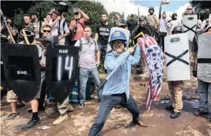  ?? PICTURE: EVELYN HOCKSTEIN FOR THE WASHINGTON POST ?? Far-right American protesters incite hatred at a Unite the Right rally in Charlottes­ville, Virginia.