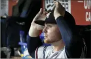  ?? ALEX BRANDON — THE ASSOCIATED PRESS FILE ?? Braves starting pitcher Sean Newcomb adjusts his cap in the dugout during recent game against the Nationals. Years-old racist, offensive tweets from Brewers reliever Josh Hader, Newcomb and Nationals shortstop Trea Turner were recently unearthed.