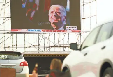  ??  ?? Arizona delegates park their cars to watch the big screen during an Arizona Democratic Party drive-in night in Mesa to view the acceptance speech of their party's nominee, Joe Biden, on Thursday.